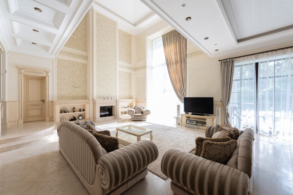 Tall windows bringing daylight into a bright cream living room